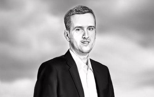 Grayscale sketch portrait of a smiling man in a dark suit jacket and white shirt against cloudy sky.