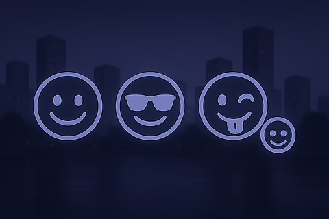 Neon blue glowing smileys—happy, cool shades, winking tongue-out, tiny smile—over dark city skyline at night.