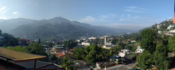 Panoramabild: Stadt, Berge und Wald